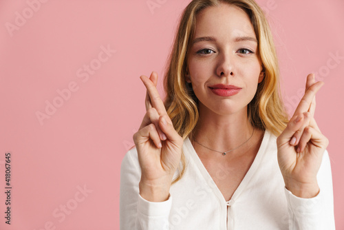 Smiling lovely young woman with long hair holding fingers