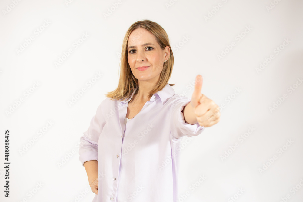 Smiling pretty young woman showing thumb up isolated over white background Smiling pretty young woman showing thumb up isolated over white background