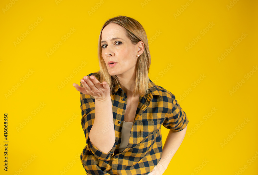 portrait of beautiful woman in plaid shirt sending an air kiss portrait of beautiful woman in plaid shirt sending an air kiss