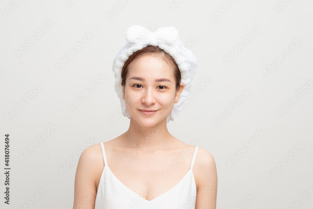 Portrait of beautiful young woman after shower on light background Portrait of beautiful young woman after shower on light background