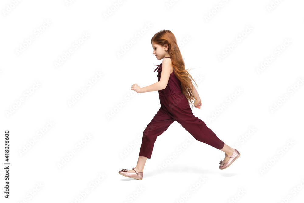 Jumping, running. Happy, smiley little caucasian girl isolated on white studio background with copyspace for ad. Looks happy, cheerful. Childhood, education, human emotions, facial expression concept. Jumping, running. Happy, smiley little caucasian girl isolated on white studio background with copyspace for ad. Looks happy, cheerful. Childhood, education, human emotions, facial expression concept.
