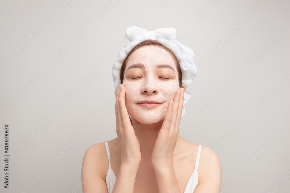 Spa dreams. A portrait of a beautiful relaxing lady with a clay mask on her face. Spa dreams. A portrait of a beautiful relaxing lady with a clay mask on her face.