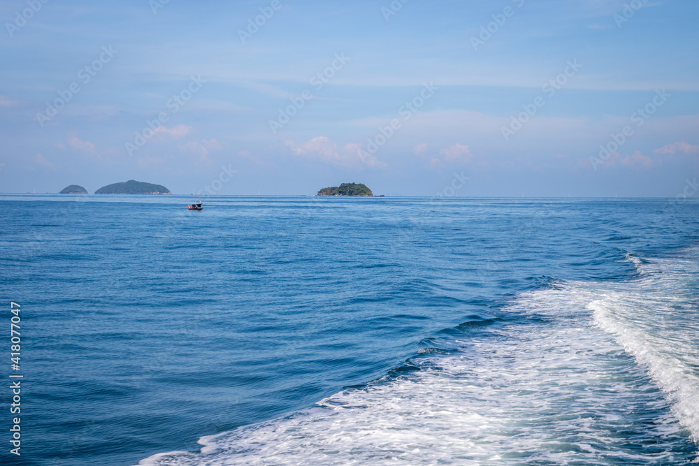 a background of sea ocean with waves and small island and mountain and sky
