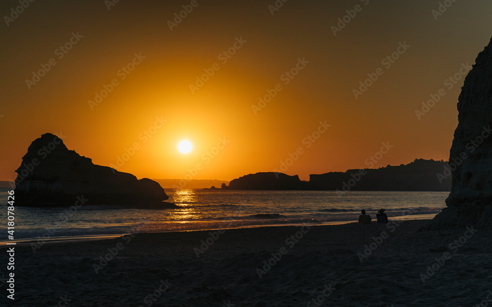 Couple Silhouette at sunset in the beach, Algarve, Portugal
