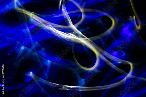 3D rendered or 3D illustration. Abstract shapes of blue and yellow colors on black background. Abstract art made with light painting.