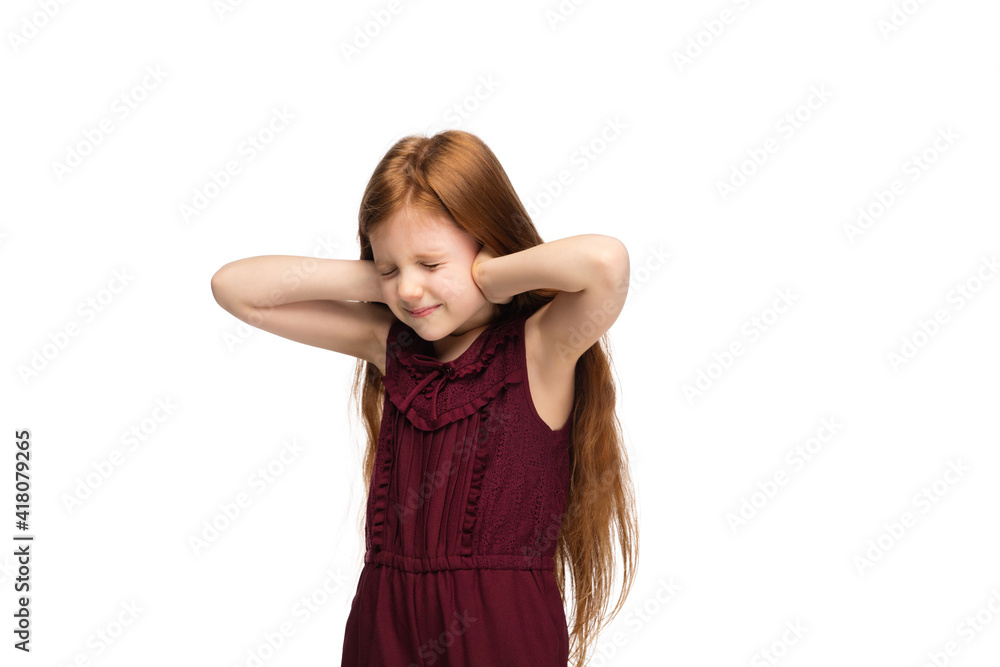 Scared, closing ears. Happy, smiley little caucasian girl isolated on white studio background with copyspace for ad. Looks happy, cheerful. Childhood, education, human emotions, facial expression Scared, closing ears. Happy, smiley little caucasian girl isolated on white studio background with copyspace for ad. Looks happy, cheerful. Childhood, education, human emotions, facial expression