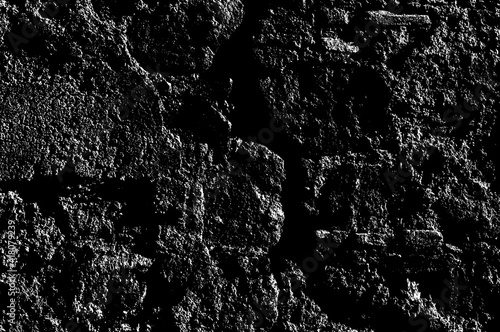 Texture of medieval crumbling stone basement wall. Large hard cobblestones of natural rocky block cement structure. Dirty broken bumpy shabby daub. Retro aged vintage messy masonry for design material
