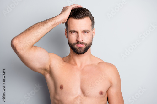 Close-up portrait of attractive perfect well-groomed fit brunet guy touching coiffure isolated over light grey color background