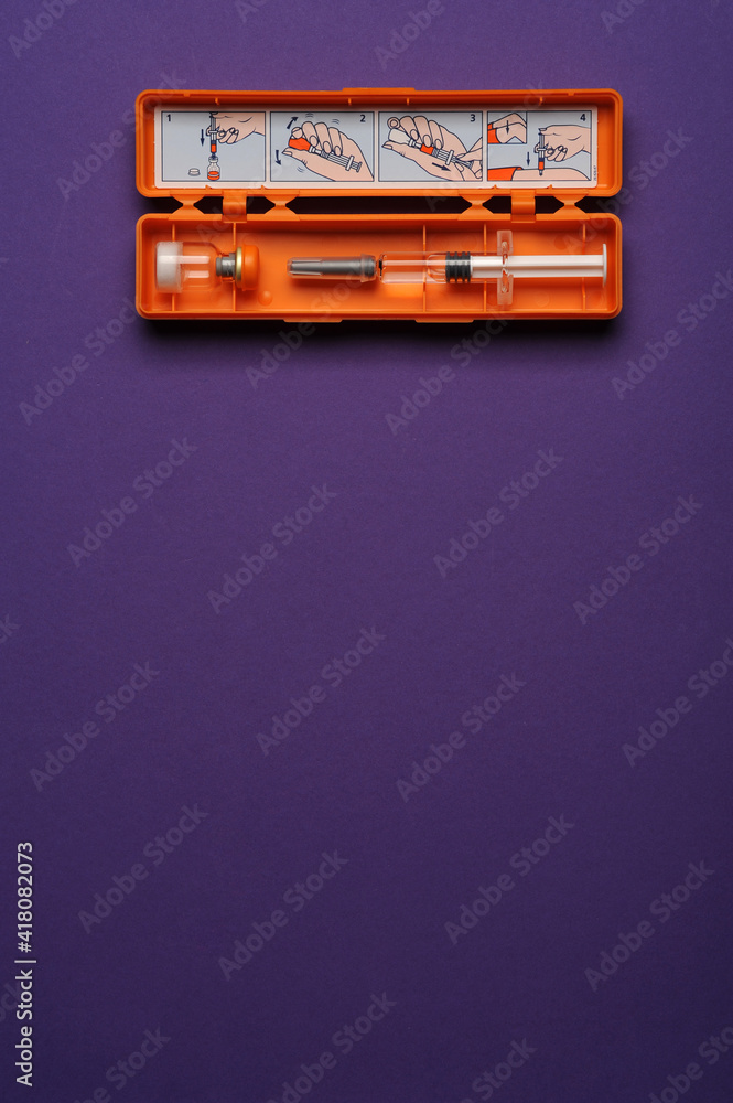 syringe with glucagon on purple background. Diabetes. Diabetic coma. Hypoglycemia. syringe with glucagon on purple background. Diabetes. Diabetic coma. Hypoglycemia.