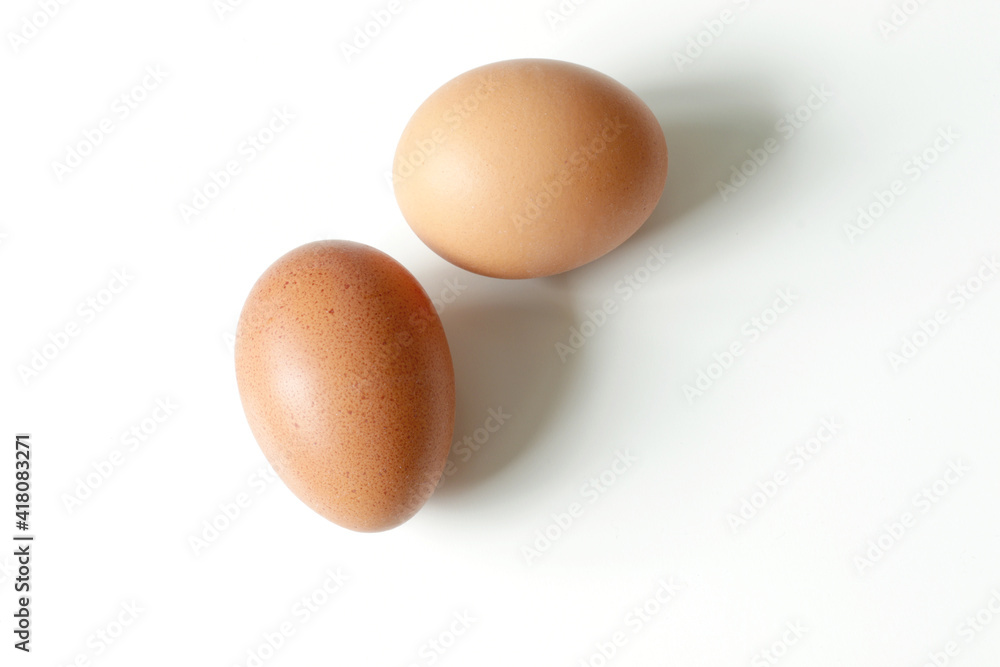 minimalism food photography, raw fresh brown egg on white background minimalism food photography, raw fresh brown egg on white background