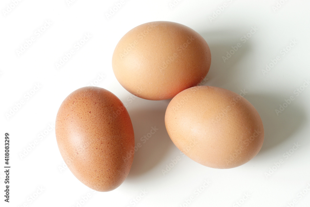 minimalism food photography, raw fresh brown egg on white background minimalism food photography, raw fresh brown egg on white background