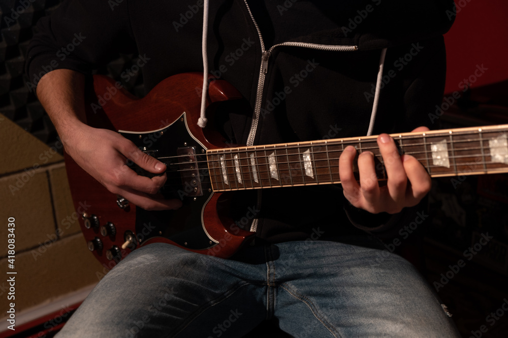 Fototapeta premium Man playing the guitar at the studio