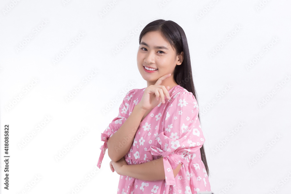 Portrait Asian beautiful woman in pink dress and black long hair. Her hands touch cheek, smile, show beautiful skin on white background. Portrait Asian beautiful woman in pink dress and black long hair. Her hands touch cheek, smile, show beautiful skin on white background.
