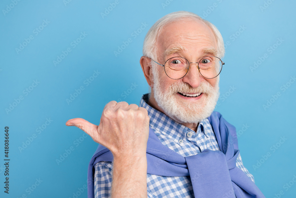 Profile photo of optimistic old grey hairdo man point empty space wear spectacles blue shirt isolated on pastel color background Profile photo of optimistic old grey hairdo man point empty space wear spectacles blue shirt isolated on pastel color background