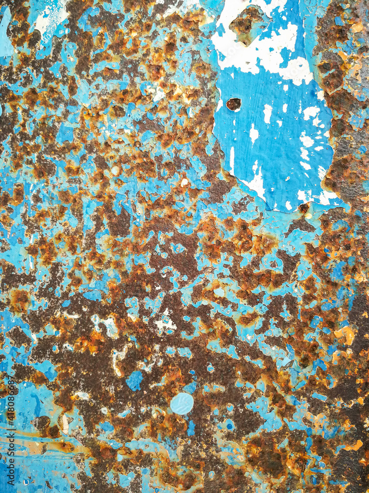 The old blue colored surface peels off the metal surface caused by rust corrosion. The old blue colored surface peels off the metal surface caused by rust corrosion.