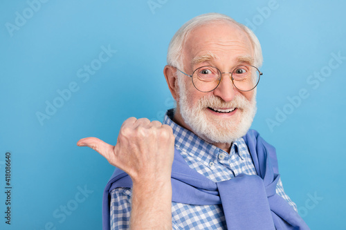 Profile photo of optimistic old grey hairdo man point empty space wear spectacles blue shirt isolated on pastel color background