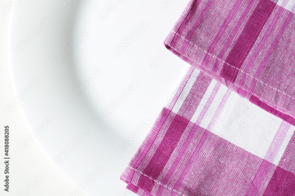 empty white dining plate and pink plaid kitchen towel close up empty white dining plate and pink plaid kitchen towel close up
