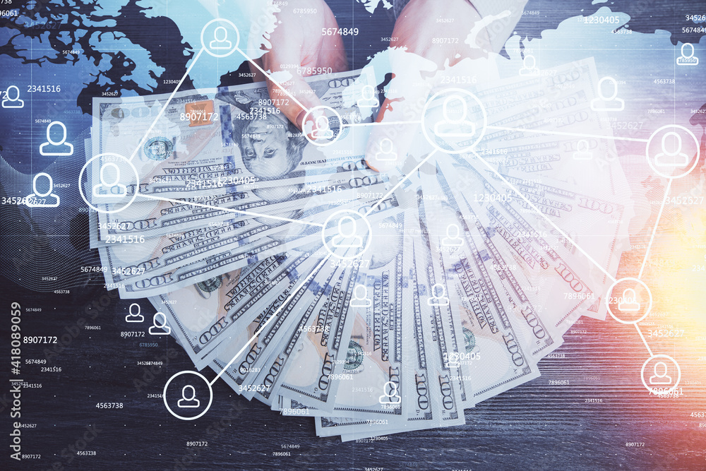 Multi exposure of social network theme drawing hologram and USA dollars bills and man hands. Multi exposure of social network theme drawing hologram and USA dollars bills and man hands.