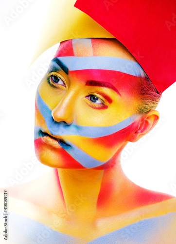 woman with creative geometry make up, red, yellow, blue closeup smiling colored, bright concept