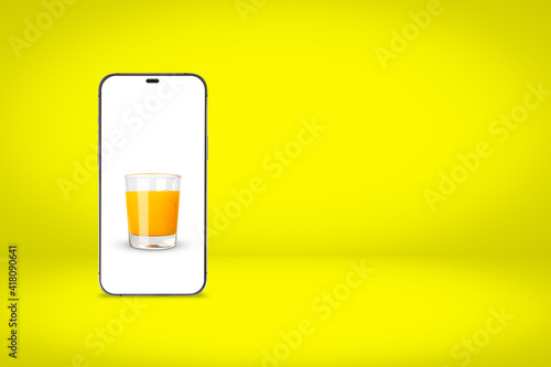 White screen smartphone with a picture of orange juice on a yellow background with copy space. Free Download White screen smartphone with a picture of orange juice on a yellow background with copy space. - GFXLoad