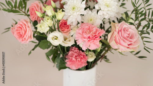 Bouquet of fresh spring flowers on light pink wall background 