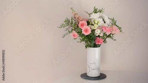 Bouquet of fresh spring flowers on light pink wall background 