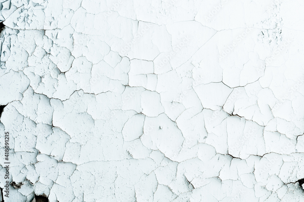 Many small cracks on the yellowed surface. Very old faded white paint, vintage background close-up, rough textured surface.