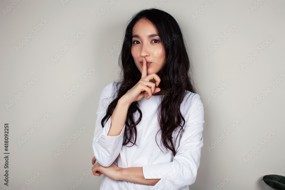 young asian woman doctor in white uniform gesturing positive on gray background, lifestyle healthcare people concept young asian woman doctor in white uniform gesturing positive on gray background, lifestyle healthcare people concept