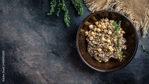 Vegan salad with quinoa, chickpeas and thyme. Super food. Black background. Long banner format, top view