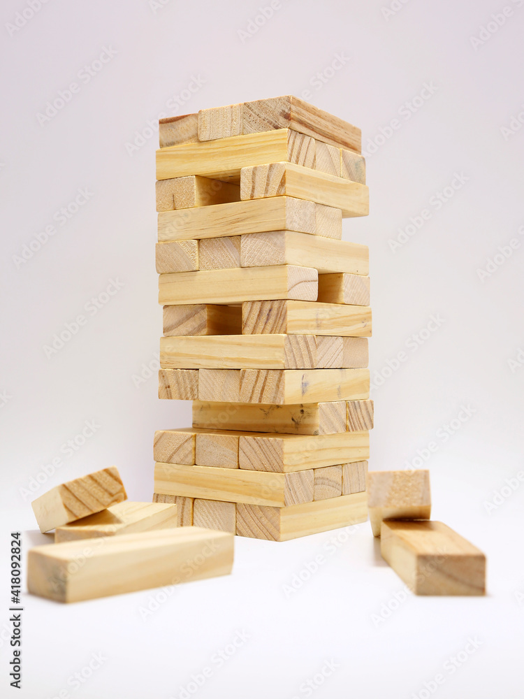Jenga Classic Wood Game. Board game. Game of physical skill and balance. Tower built with wooden blocks. Jenga Classic Wood Game. Board game. Game of physical skill and balance. Tower built with wooden blocks.