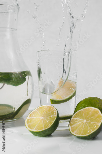 Detox water with lime fruit and mint leaves. Mint fresh homemade lemonade © vladdeep