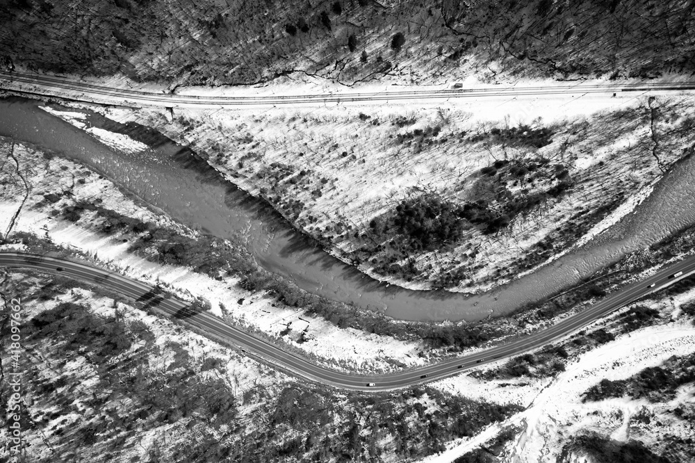Fototapeta premium Aerial view on mountain road from drone in winter.