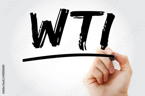 WTI - West Texas Intermediate acronym with marker, business concept background