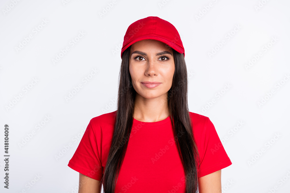 Photo of young beautiful stunning lovely delivery woman in red t-shirt and headwear isolated on grey color background Photo of young beautiful stunning lovely delivery woman in red t-shirt and headwear isolated on grey color background