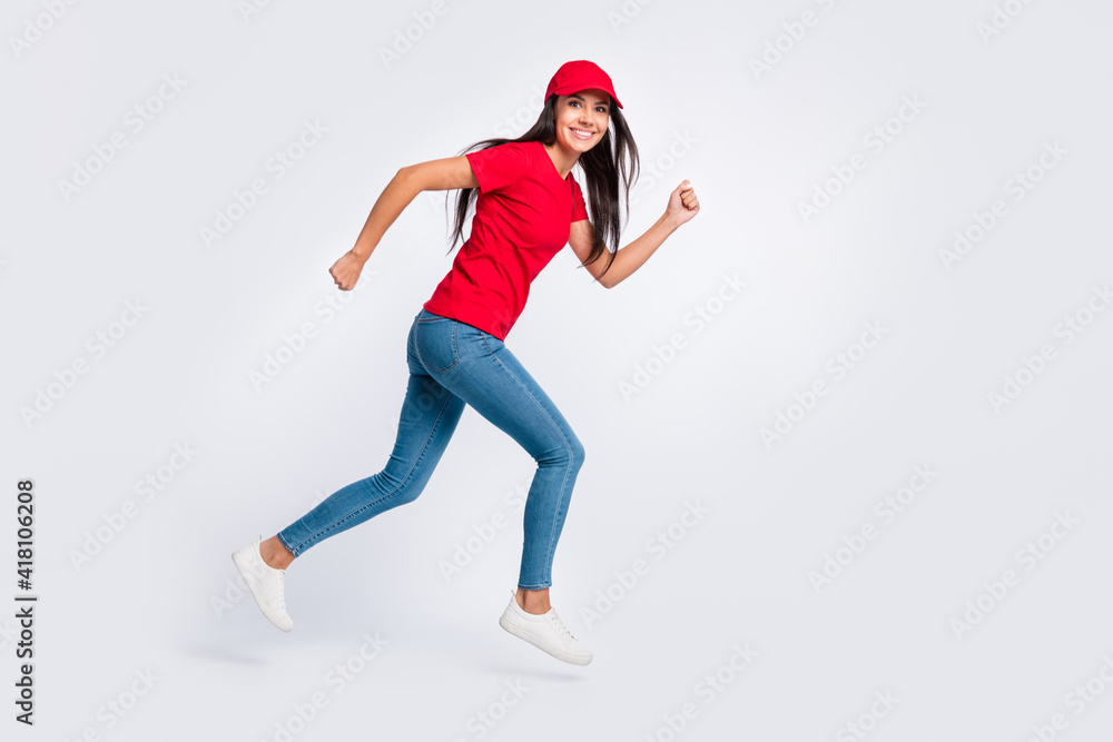 Full size profile side photo of young happy excited delivery girl running in air fast speed isolated on grey color background