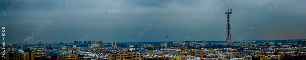 Panoramic cityscape of Minsk downtown in twilight. Roofs of houses and television tower on dramatic sky background.