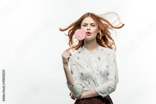 pretty woman holding lollipop near face emotions luxury enjoyment