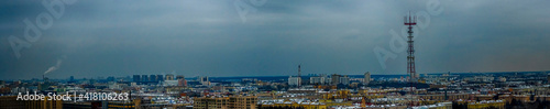 Panoramic cityscape of Minsk downtown in twilight. Roofs of houses and television tower on dramatic sky background.
