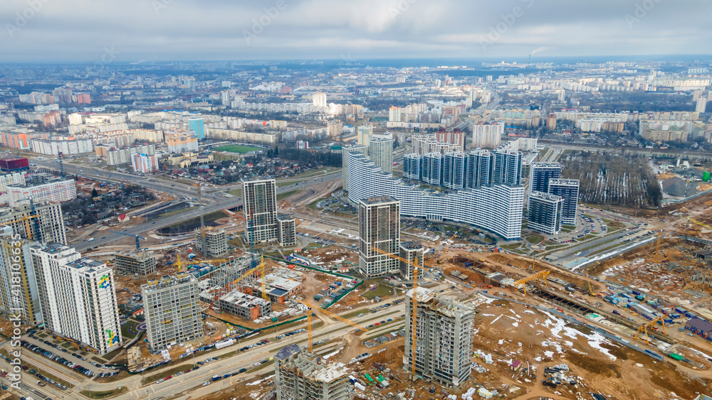 Construction of high-rise resedential buildings. The construction industry with working equipment. View from above. Eye bird view of new resedential district. Construction of high-rise resedential buildings. The construction industry with working equipment. View from above. Eye bird view of new resedential district.