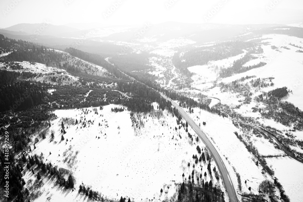 Aerial view on mountain road from drone in winter.