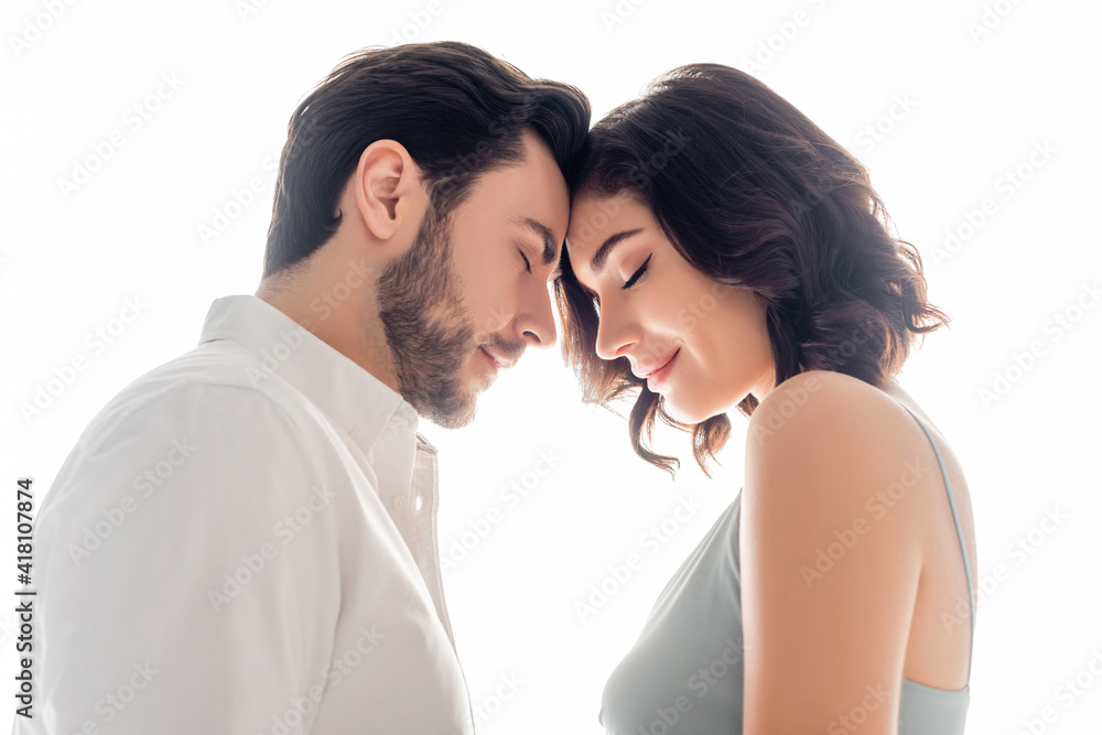 Side view of man standing with closed eyes near wife isolated on white Side view of man standing with closed eyes near wife isolated on white