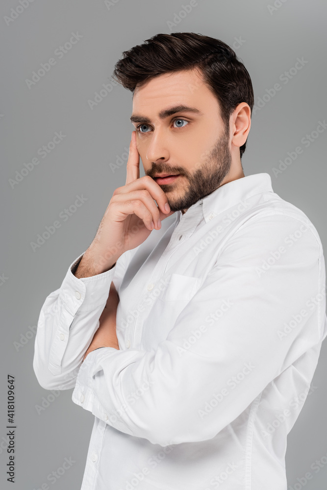 Young bearded man in white shirt isolated on grey Young bearded man in white shirt isolated on grey