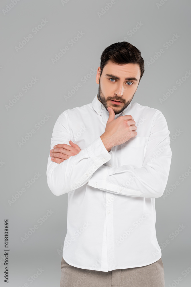 Brunette an in white shirt looking at camera isolated on grey Brunette an in white shirt looking at camera isolated on grey