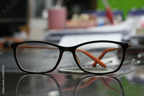 orange eyeglasses frame on the table