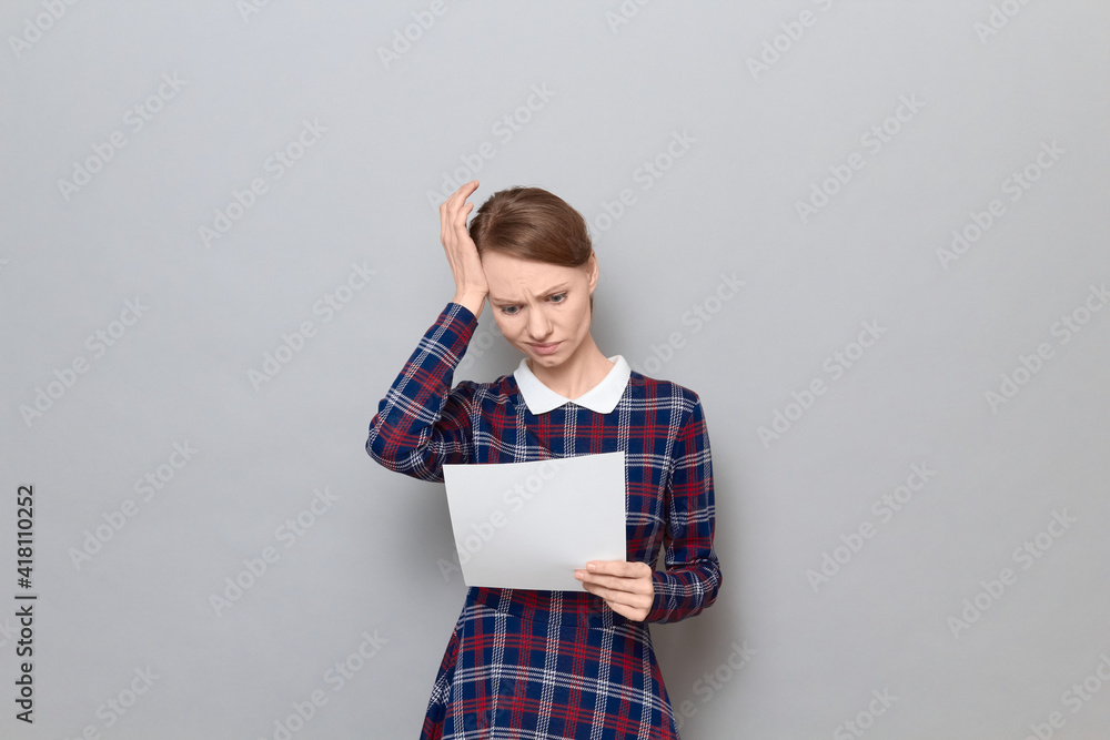 Portrait of disappointed young woman reading document Portrait of disappointed young woman reading document