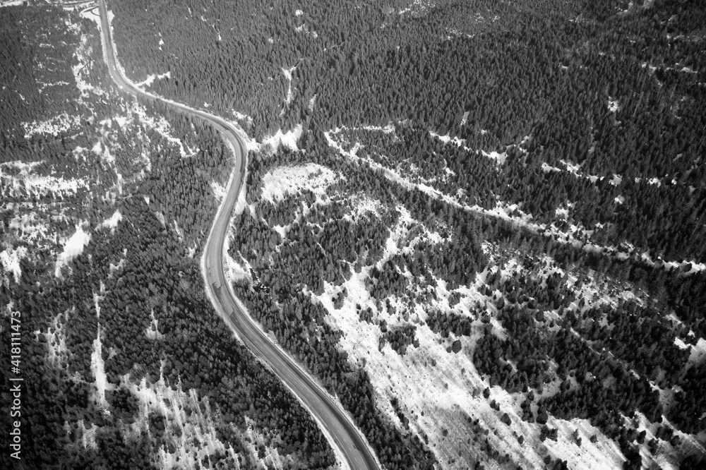 Obraz premium Aerial view on mountain road from drone in winter.