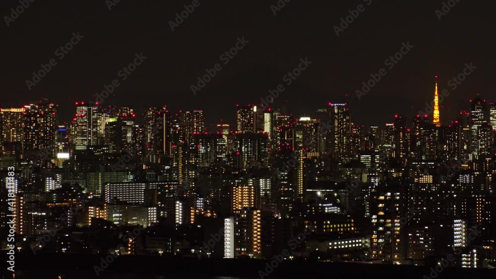 TOKYO, JAPAN : Aerial view of CITYSCAPE of TOKYO at night. View of busy central downtown area (Roppongi, Minato ward). Japanese urban metropolis and nightlife concept. Time lapse tracking shot. TOKYO, JAPAN : Aerial view of CITYSCAPE of TOKYO at night. View of busy central downtown area (Roppongi, Minato ward). Japanese urban metropolis and nightlife concept. Time lapse tracking shot.