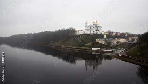 Vitebsk - skyline with the Resurrection Church, town hall and buildings on the banks of the Vitba River, Belarus. An architectural monument of the Vilna Baroque on the Assumption Hill.