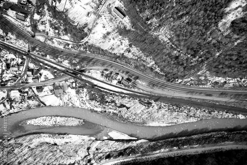 Fototapeta premium Aerial view on mountain road from drone in winter.