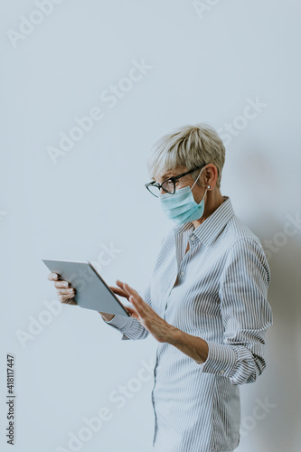 Mature businesswoman using ...
